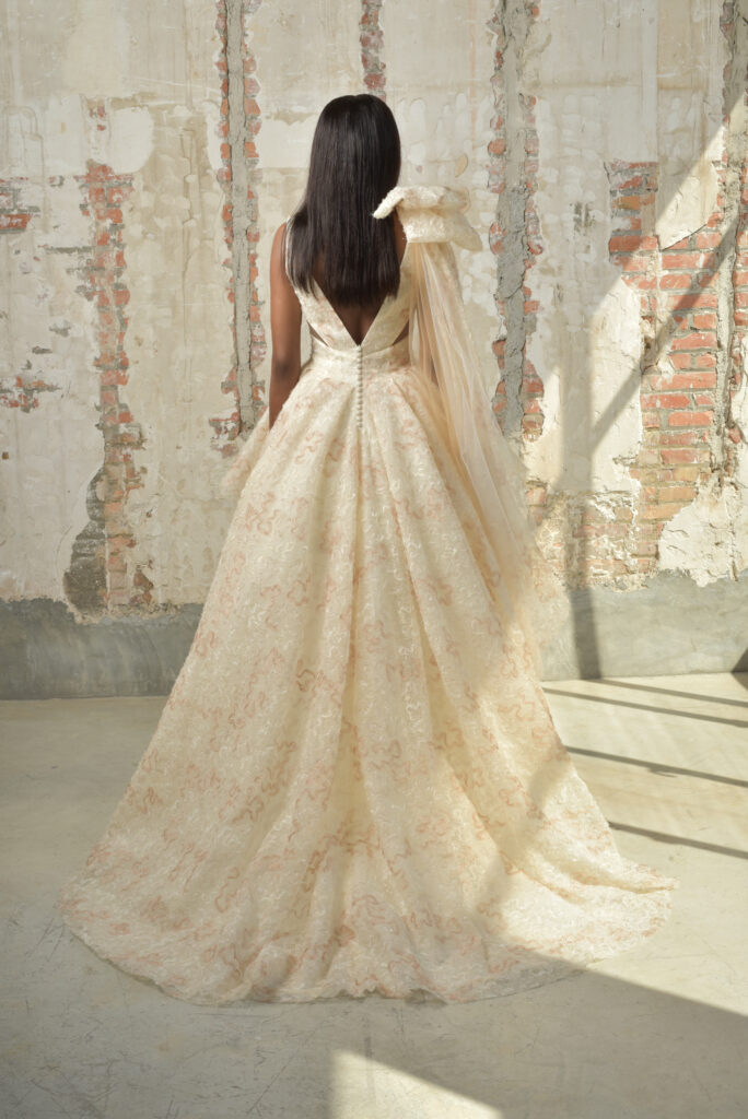 femme portant une robe de mariée originale, courte devant avec une longue traîne à l'arrière