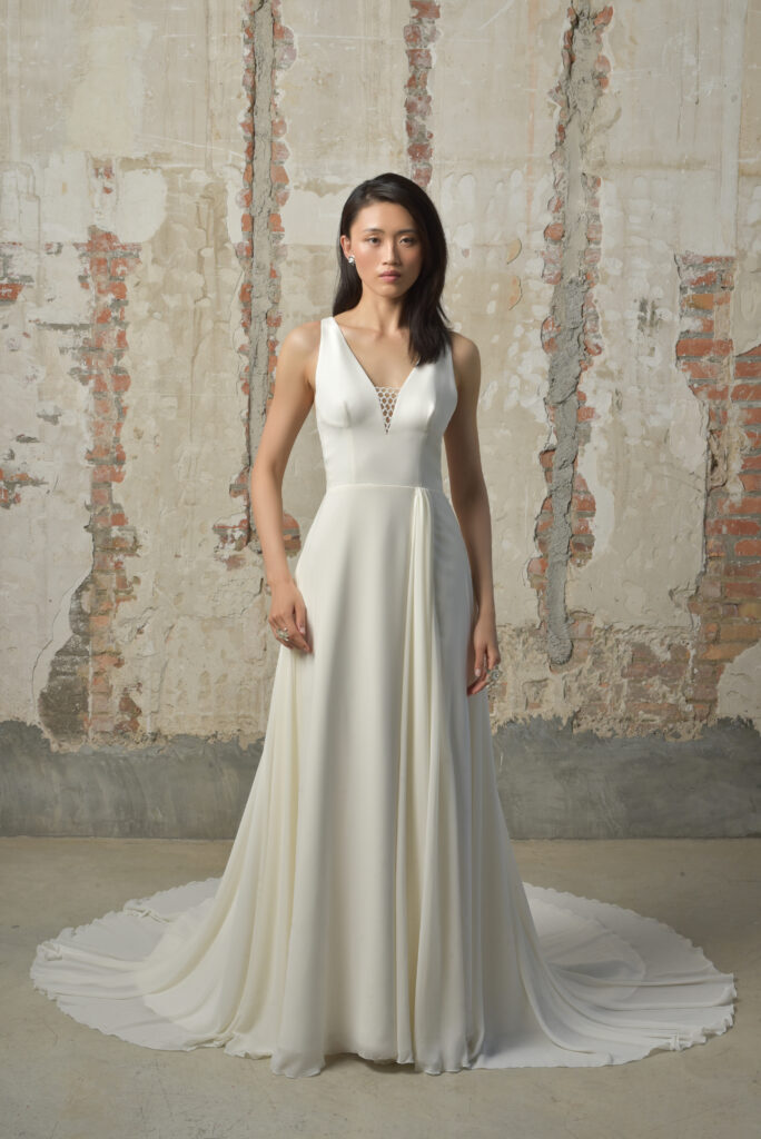 femme dans une robe de mariée fluide et épurée en guipure et en mousseline