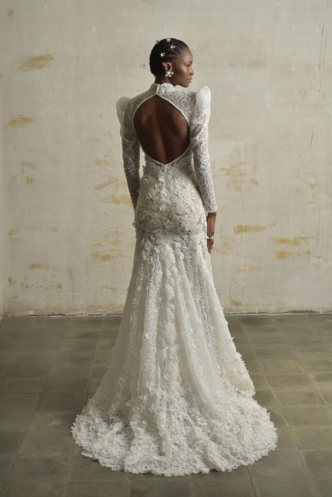 femme habillée d'une robe de mariée sirène glamour, avec des manches longues et un joli dos nu