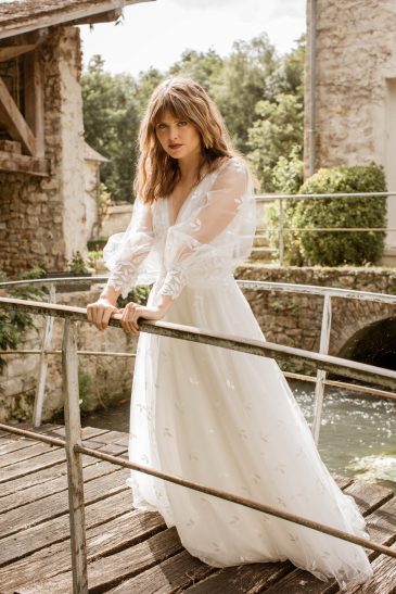 femme dans une robe de mariée bohème élégante en tulle brodé