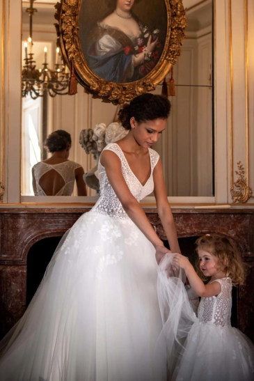 femme avec une robe de mariée et une petite fille en robe de cérémonie enfant dans un château